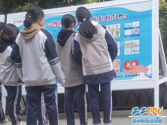 7同学们在观看心理知识宣传版面